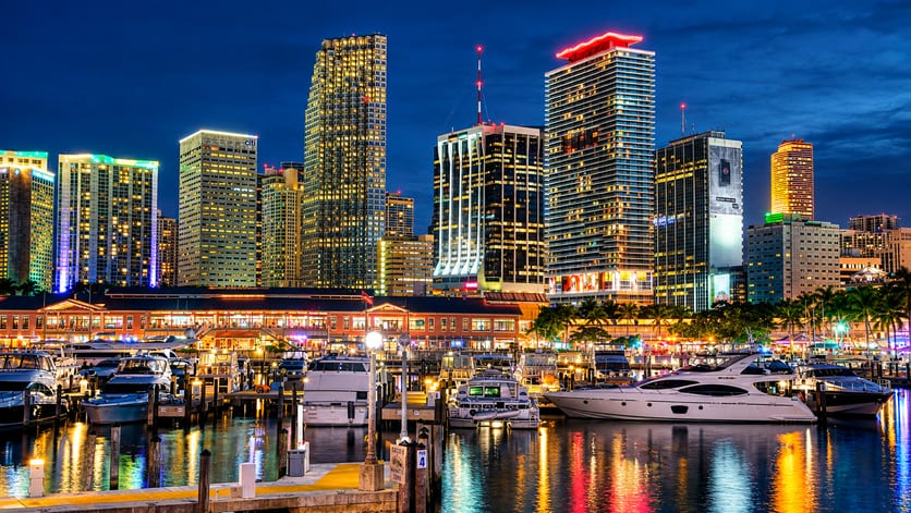 City skyline at night reflected in the marina